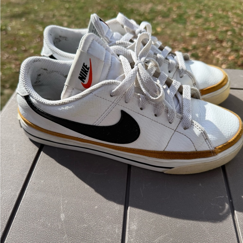 Nike Women’s White Leather Sneakers with Black Swoosh and Gold Trim